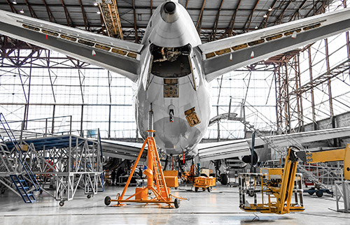 Airplane being serviced maintenance in hangar
