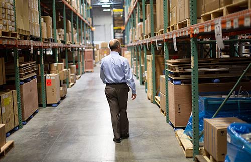 Man analyzing warehouse inventory