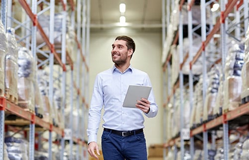Logistics manager using smart technology in warehouse
