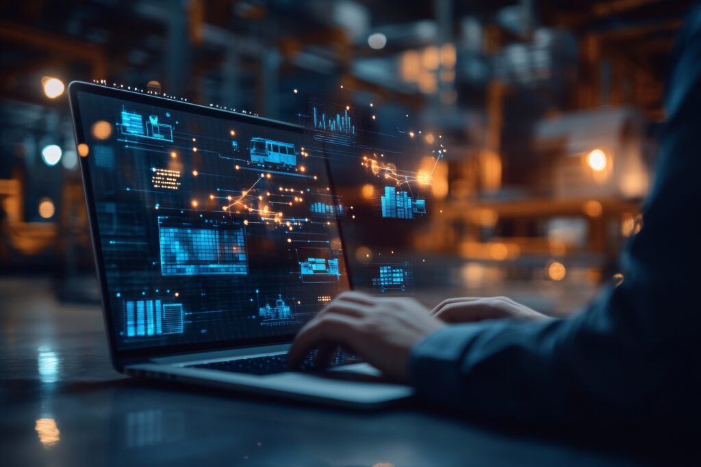 Businessman using laptop with virtual factory and logistics icons for distribution technology