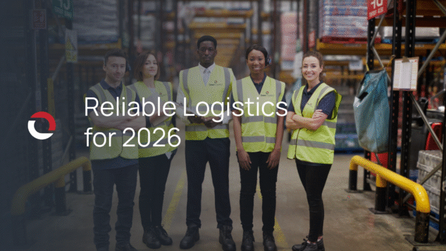 warehouse workers wearing neon vests standing in a semicircle smiling at the camera